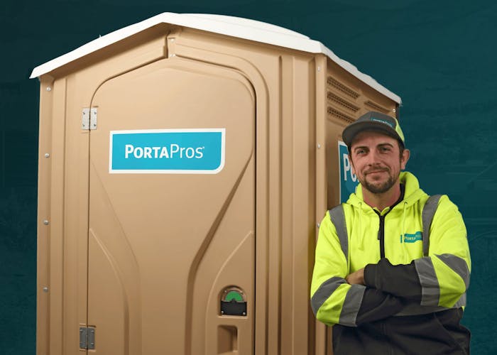 PortaPros employee leaning against portable toilet