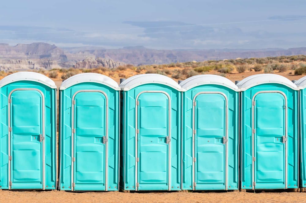 Row of porta potties with one standing out